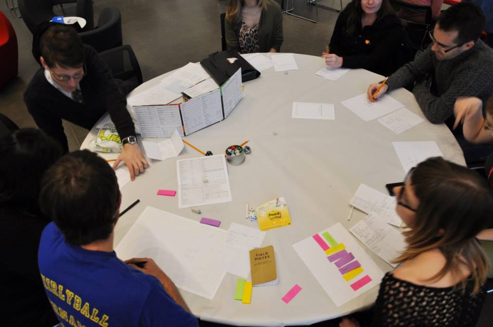 The artist leads a game at a round
		white table